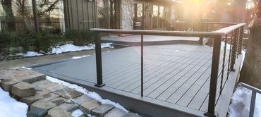 Trex composite deck in pebble grey with black cable railing.