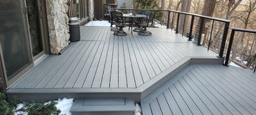 Trex composite deck in pebble grey with black cable railing.