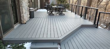 Trex composite deck in pebble grey with black cable railing.