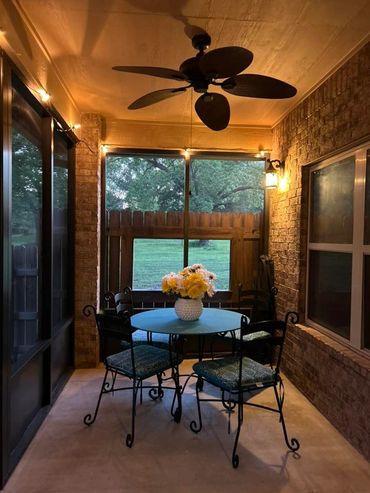 An interior view of aluminum screen patio enclosure in bronze with kick panels at the bottom.