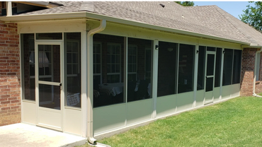 Clay colored screen room installed beneath existing patio.