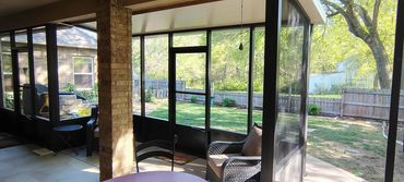 Interior view of an aluminum screen patio enclosure in bronze with kick panels at the bottom.