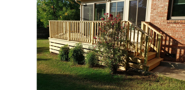 Wooden deck with fascia on front and railing, built in front of a sun room.