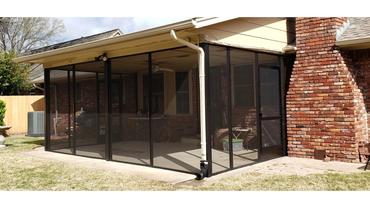 Black screen walls installed beneath existing patio.