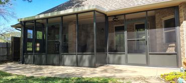 An aluminum screen patio enclosure in bronze with kick panels at the bottom.