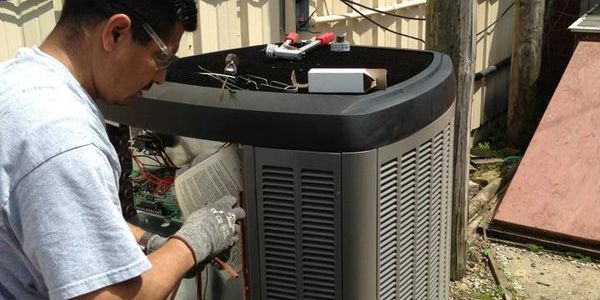 Hardon's employee installing a Dave Lennox Signature air conditioner.