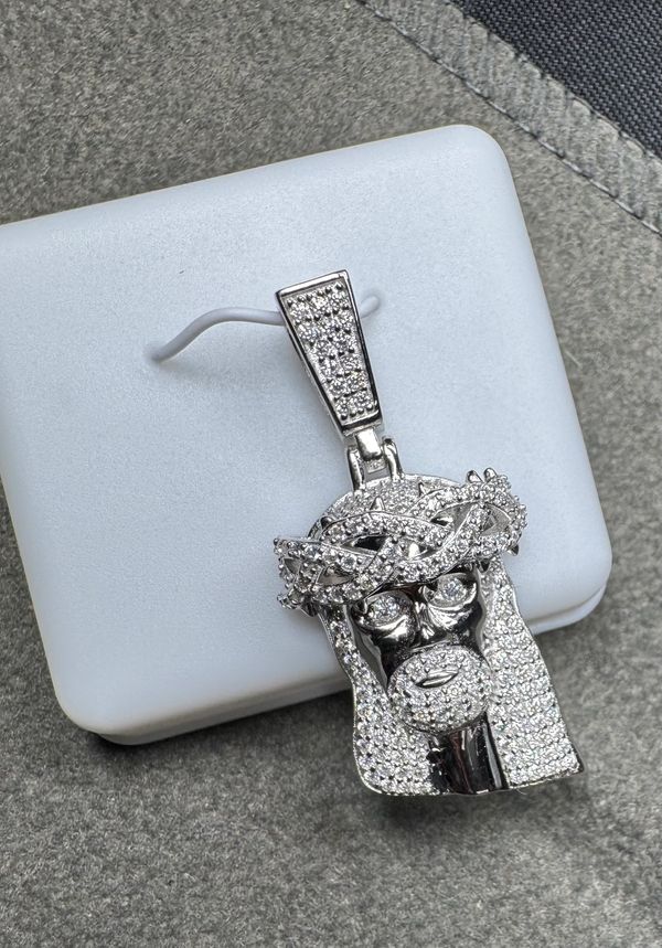 Diamond-encrusted pendant shaped like Jesus wearing a crown of thorns.