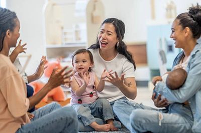 Mothers and children having fun together indoors.