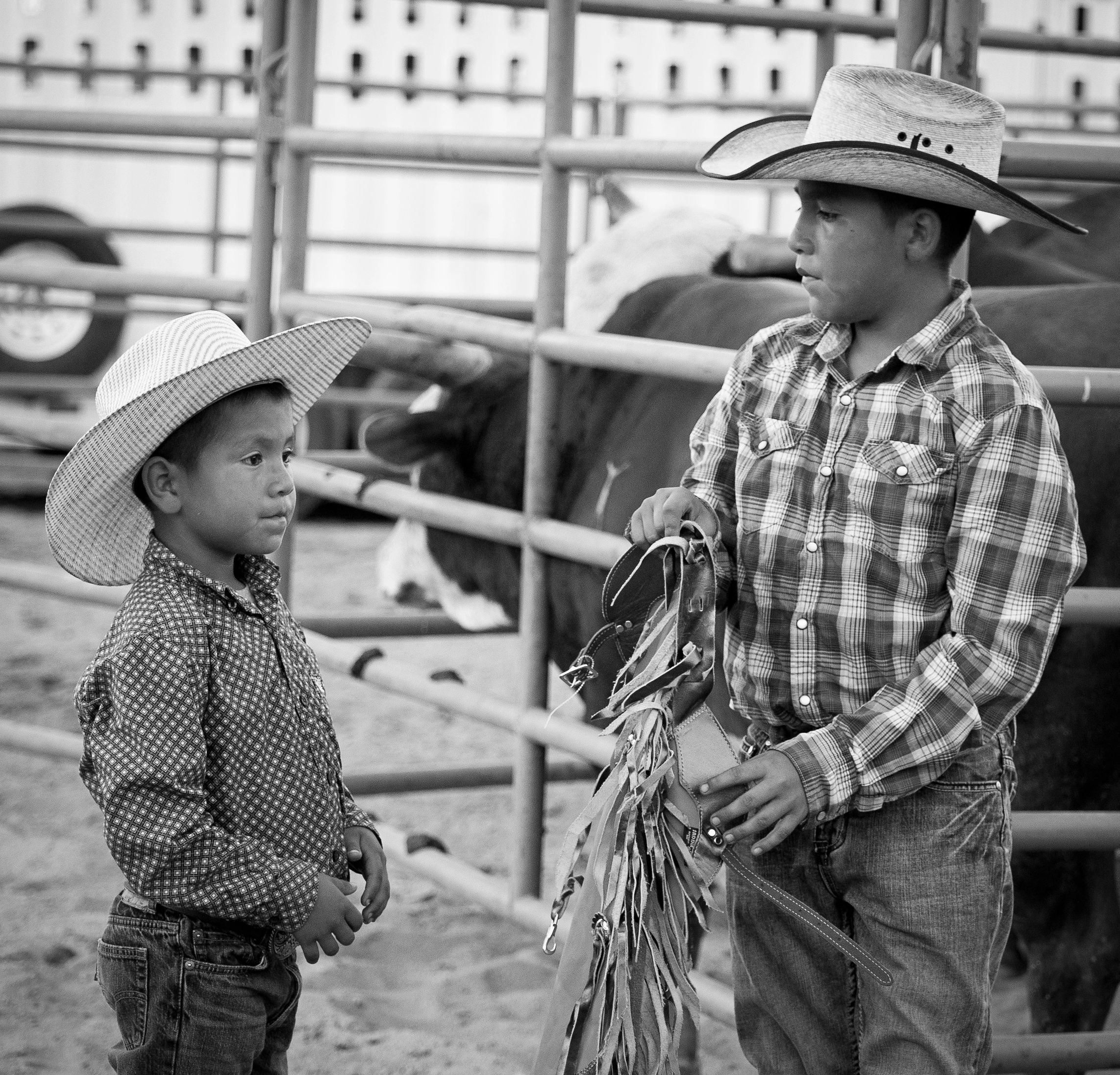 Two young boys, with ropes and  gear ,  get ready to participate at the Springville  Rodeo in Spri