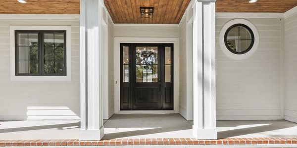 Beautiful mahogany front door and cedar tongue and groove ceiling.  Brick lined large front porch