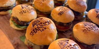 Mini burgers on a wooden serving board