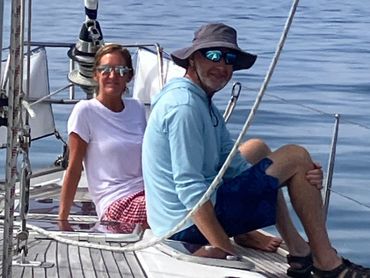 Lissa Brown and Eugene Shal enjoy a Day Sailing Adventure seated on the foredeck of Chao Lay.