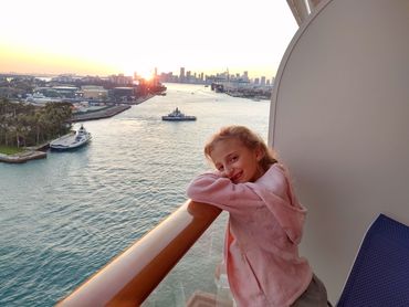 Tori enjoying the balcony view from our room on the Norwegian Escape