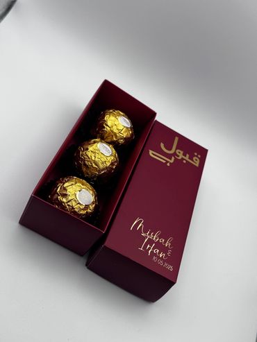 Elegant maroon box with three Ferrero Rocher chocolates, personalized with names and date.
