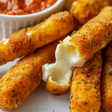 Golden mozzarella sticks with melted cheese and marinara sauce.