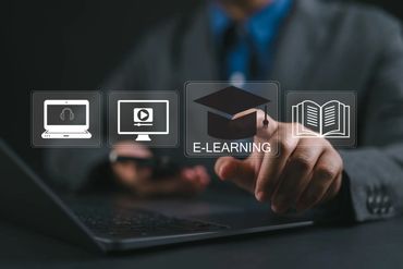 Person interacting with virtual e-learning icons above a laptop keyboard.