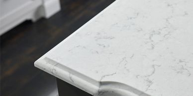 Close-up of a white marble kitchen countertop with decorative edge.