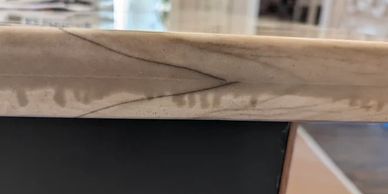 Close-up of a cracked marble countertop edge.