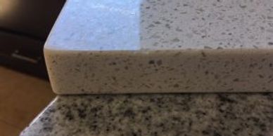 Close-up of two different granite countertop samples stacked.