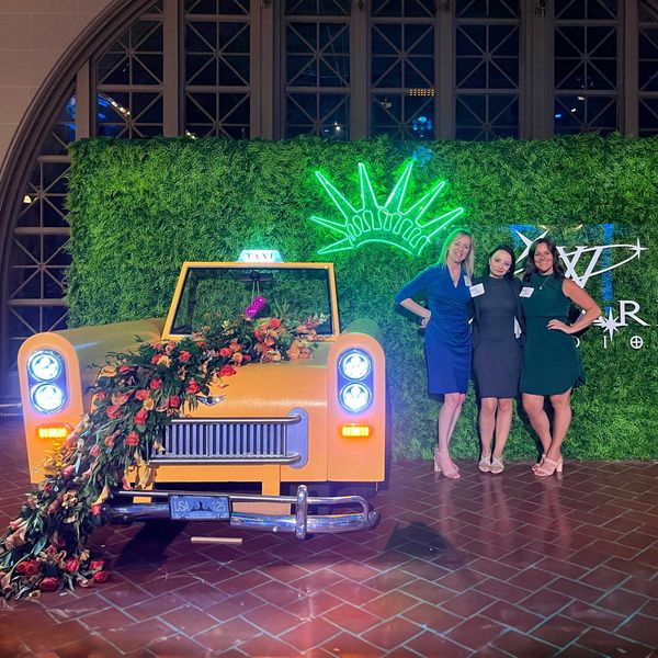 A photo showing our special events management posing at the NYC taxi cab step & repeat.