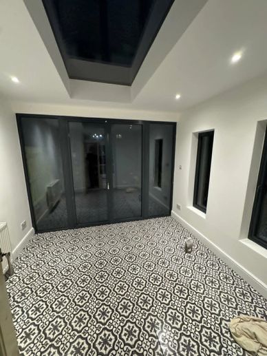 Bright conservatory living space with feature floor tiling and rooflight completed in Hanwell, West