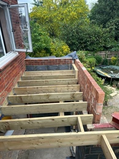 Timber flat roof structure under construction for a rear extension in Northwood HA6.