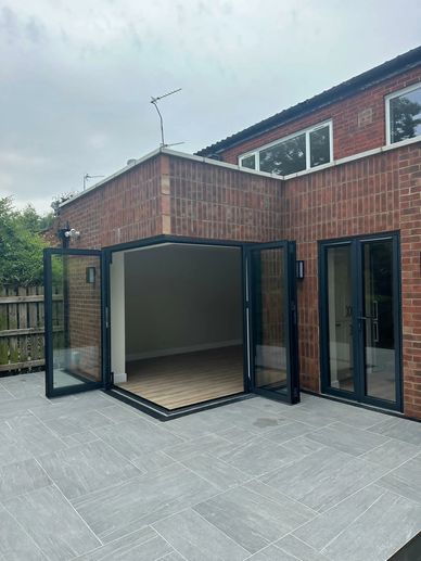 Completed kitchen and living room extension with bifold doors and porcelain patio in Northwood HA6.
