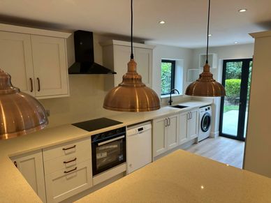 Shaker-style kitchen with quartz island, pendant lighting and integrated appliances in Northwood HA6