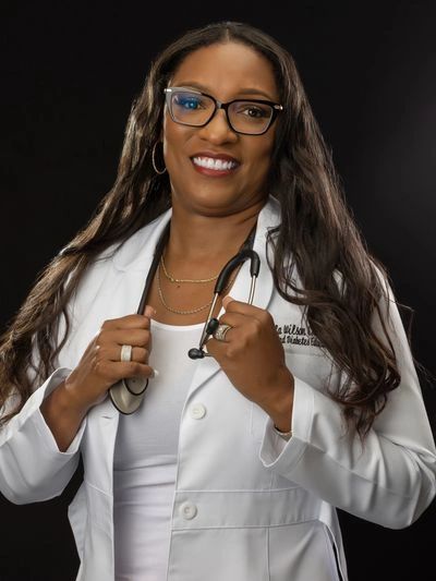Smiling female doctor with stethoscope and glasses.