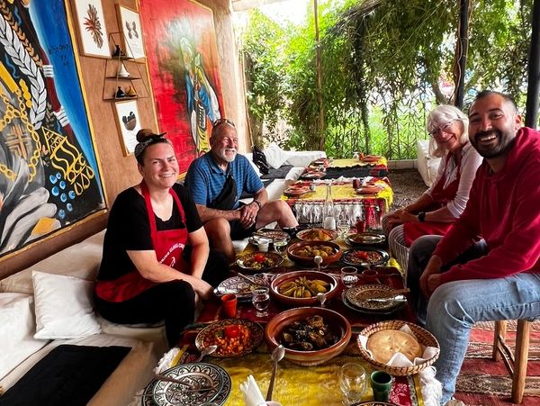 American tourists with their Moroccan tour guide enjoying a traditional cooking class with lunch