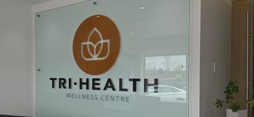 Modern reception area of TRI-HEALTH Wellness Centre with clean design and brochures.