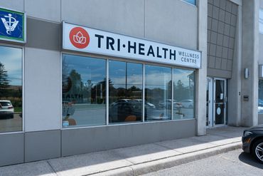 Exterior view of TRI HEALTH Wellness Centre on a sunny day.