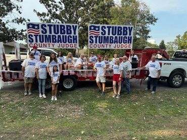 Group supporting Stubby Stumbaugh for County Judge with signs and t-shirts.