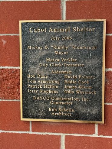Plaque commemorating the Cabot Animal Shelter from July 2006 with names of officials and contributors.