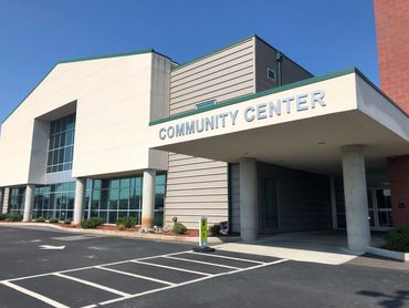 Modern community center building under clear blue sky.