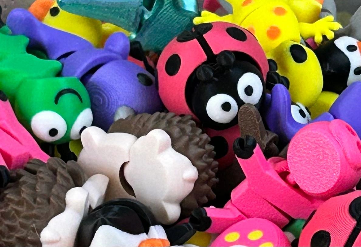 Colorful cartoon erasers shaped like various animals and insects.