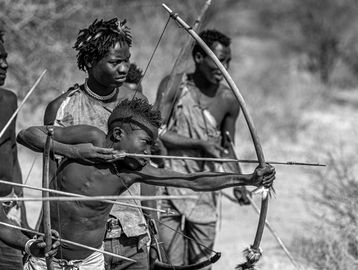 Young archers practicing traditional bow and arrow skills.
