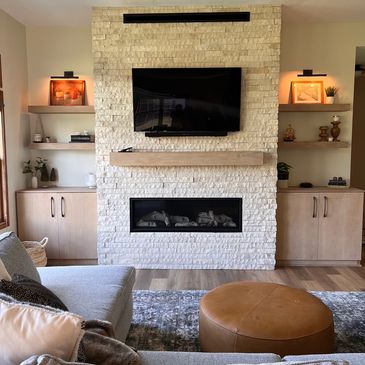 The finished living room remodel product, featuring the completed stone fireplace.