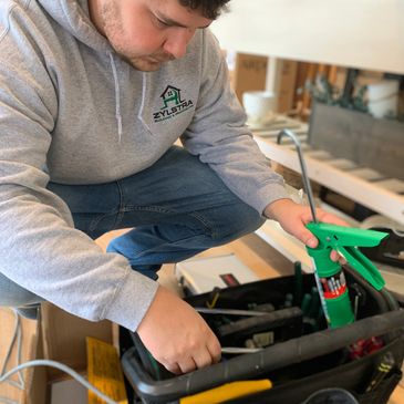 Worker organizing and looking through tool bag.