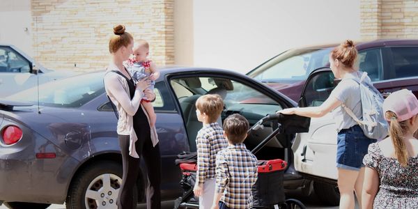 People are parking and entering the worship service.