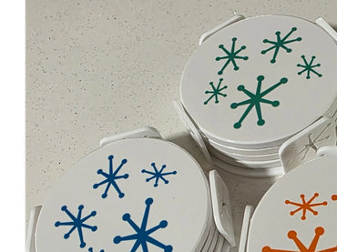 Three stacks of round cards with colorful starburst patterns.