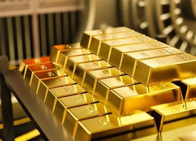 Stacks of shiny gold bars neatly arranged on a table.