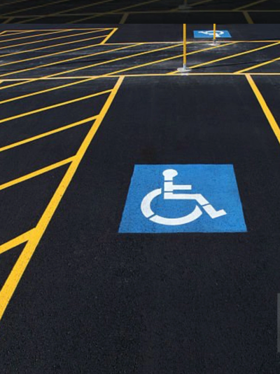 Handicap parking spaces with clear markings on asphalt.