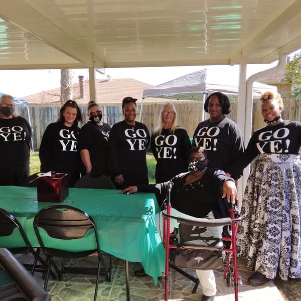 Picture of 9 people with GO YE Shirts
