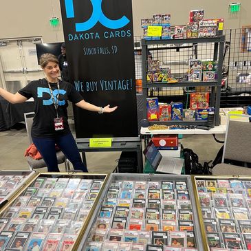 Vendor showcasing vintage collectible cards at Dakota Cards booth.