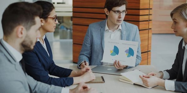 Team of professionals collaborating during a business coaching and strategy session focused on growth, planning, and performance.