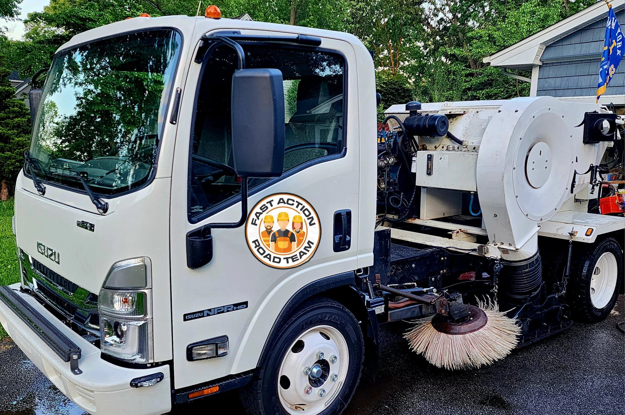 2024 Tymco 210 Air Sweeper on an Isuzu cab with Fast Action Road Team Sweeping Logo.