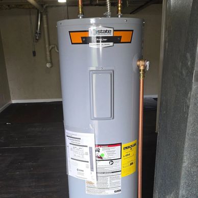 New gray water heater with copper piping installed indoors.