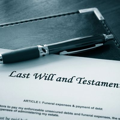 A close-up of a "Last Will and Testament" document with a pen on top.