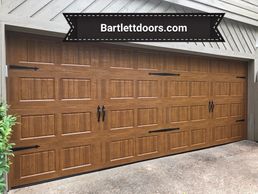 Wood grain carriage door installed by Bartlett Garage Doors in Memphis, TN bartlettdoors.com